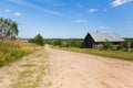 Wooden house and country road, rural landscape. Remote village in Karelia Republic