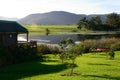 Wooden house on dam with canoes in the Garden Route, South Africa Royalty Free Stock Photo