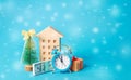 Wooden house, dollar bills, Christmas tree, gifts and alarm clock. New Year Holidays. Accumulating money and planning a budget. Royalty Free Stock Photo
