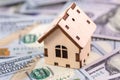 Wooden house with dollars banknotes Royalty Free Stock Photo