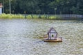 Wooden house for duck on water. Artificial housing for wild birds on the city lake. Selective focus