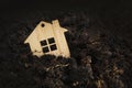 Wooden house falls into ground. under the ground home mortgage, house for sale, real estate crisis concept, copy space. owe Royalty Free Stock Photo