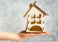 Wooden house in female hands as a symbol. Stay home to reduce the risk of infection and spread of the virus Royalty Free Stock Photo