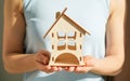 Wooden house in female hands as a symbol. Stay home to reduce the risk of infection and spread of the virus Royalty Free Stock Photo