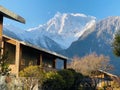 The wooden house at the foot of the snowy mountain