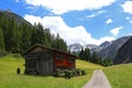 Wooden house with wooden frames for hay drying in the mountains of Austria