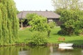 Dutch wooden home, garden and boat along canal, Netherlands Royalty Free Stock Photo