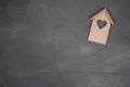 Wooden house on a gray stone background. Buying a house with a young family. Affordable housing. banner. Family Royalty Free Stock Photo