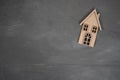 Wooden house on a gray stone background. Buying a house with a young family. Affordable housing. banner. Family Royalty Free Stock Photo