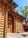 A wooden house on a green meadow in mountains. A house near old forest. Lifestyle in the Carpathian village. Royalty Free Stock Photo