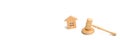 Wooden house and hammer of the judge on a white background. trial property. The court decision on the transfer of property, the na