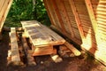 Wooden house, hut in the forest for tourists, fishermen and hunters for rest and cooking Royalty Free Stock Photo