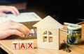 Wooden house with the inscription `Tax`. Taxes on real estate, payment. Penalty, arrears. Register of taxpayers for property. Law-