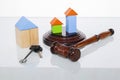 Wooden house and judge gavel on a white background. Is isolated Royalty Free Stock Photo