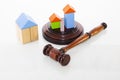 Wooden house and judge gavel on a white background. Is Royalty Free Stock Photo