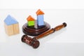 Wooden house and judge gavel on a white background. Is isolated Royalty Free Stock Photo