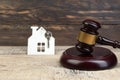 Wooden house, judge`s gavel on wooden background. purchase, sale of real estate. housing. Royalty Free Stock Photo