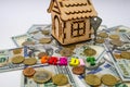 A model of a wooden house with a key, money and the word `credit` from letters. real estate, mortgage and investment concept. Royalty Free Stock Photo