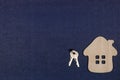 Wooden house and keys on a gray-blue background. The concept of love, happiness in your home. Real estate Royalty Free Stock Photo