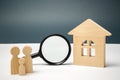 Wooden house and magnifying glass with family. Property valuation. Choice of location for the construction. House searching Royalty Free Stock Photo