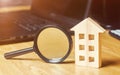 Wooden house and magnifying glass. Property valuation. Choice of location for the construction. House searching concept. Search Royalty Free Stock Photo