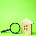 Wooden house and magnifying glass. Property valuation. Choice of location for the construction. House searching concept. Search Royalty Free Stock Photo