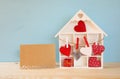 Wooden house with many hearts next to letter on the table Royalty Free Stock Photo