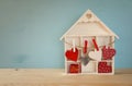 Wooden house with many hearts on the table Royalty Free Stock Photo