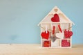 Wooden house with many hearts on the table Royalty Free Stock Photo