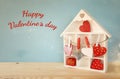 Wooden house with many hearts on the table Royalty Free Stock Photo