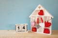 Wooden house with many hearts on the table Royalty Free Stock Photo