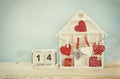 Wooden house with many hearts on the table Royalty Free Stock Photo