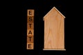 wooden house mockup with house keys, wooden cubes with words rent sale , buy and loan. on black background