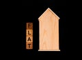 wooden house mockup with house keys, wooden cubes with words rent sale , buy and loan. on black background