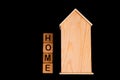 wooden house mockup with house keys, wooden cubes with words rent sale , buy and loan. on black background