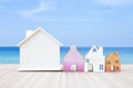 Wooden house model collections over beach background Royalty Free Stock Photo