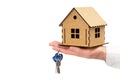 Wooden house model and keys in hand isolated Royalty Free Stock Photo