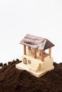 Wooden house model on the pile of soil Royalty Free Stock Photo