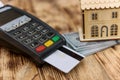 Wooden house model with terminal and credit card
