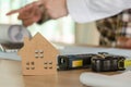 Wooden house model and tools on workplace desk with construction worker team working for start up plan new project contract in off Royalty Free Stock Photo