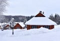 Wooden house in mountain in winter time. Log cabin in forest alone in wilderness. Wooden house with a wooden roof against Royalty Free Stock Photo