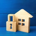 Wooden house with a padlock. Buying a home. House with a lock. Security and safety, collateral, loan for a mortgage. Confiscation