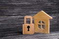 Wooden House With A Padlock. House With A Lock. Security And Safety, Collateral, Loan For A Mortgage. Confiscation Of Property For