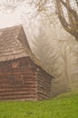 Wooden house in Podsip mountain village during misty morning in Sipska Mala Fatra mountains Royalty Free Stock Photo