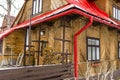 Wooden house in the Polish mountains with a red tin roof covered with snow and ice. Royalty Free Stock Photo