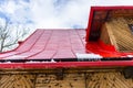 Wooden house in the Polish mountains with a red tin roof covered with snow and ice. Royalty Free Stock Photo