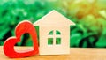 Wooden house and red heart. Concept of sweet home. Property insurance. Family comfort. Affordable housing for young families. Royalty Free Stock Photo