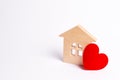Wooden house with a red heart on a white background. Love nest, love relationships. Buying a house with a young family. Affordable Royalty Free Stock Photo