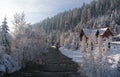Wooden House on river side in snowy mountain forest in winter Royalty Free Stock Photo