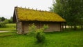 Wooden house with a roof covered with moss Royalty Free Stock Photo